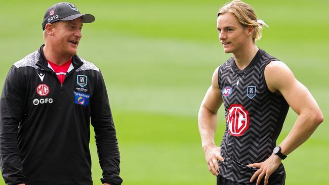 Port Adelaide youngster Miles Bergman gets some tips from Michael Voss.