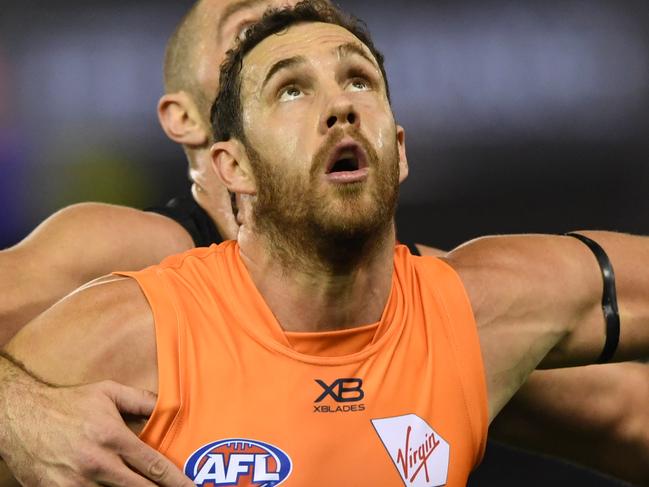 Shane Mumford of the Giants (front) and Tom Bellchambers of the Bombers contest during the Round 15 AFL match between the Essendon Bombers and the GWS Giants at Marvel Stadium in Melbourne, Thursday, June 27, 2019. (AAP Image/Julian Smith) NO ARCHIVING, EDITORIAL USE ONLY