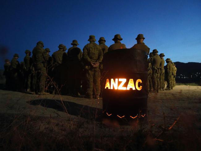 As the sun rose over the Hindu Kush Mountains in eastern Afghanistan, soldiers from 3RAR gathered to remember former members of the battalion. Picture: Gary Ramage