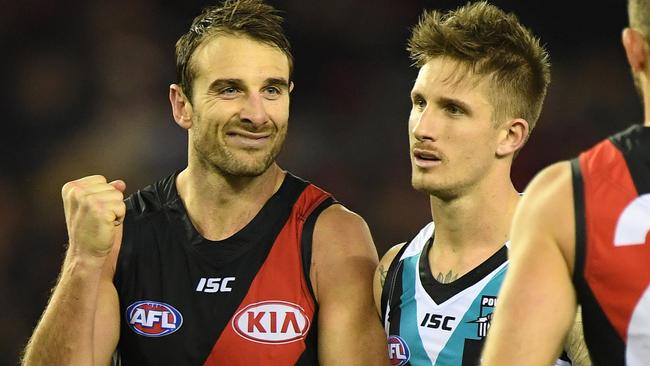 Jobe Watson of the Bombers reacts after kicking a goal against Port’s Hamish Hartlett.