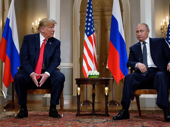 (FILES) Russian President Vladimir Putin (R) and US President Donald Trump are pictured before a meeting in Helsinki, on July 16, 2018. Putin told his US counterpart Donald Trump in a phone call on February 12, 2025 that "peaceful negotiations" on ending the Ukraine conflict were possible, the Kremlin said. "President Putin ... agreed with Trump that a long-term settlement could be reached through peaceful negotiations," the Kremlin said in its readout of the call, which it said lasted almost one-and-a-half hours. (Photo by Brendan Smialowski / AFP)