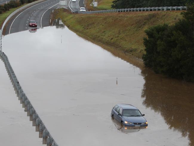 A car stuck on the Bass Highway at the Birralee Rd overpass near Westbury. Picture: BRUCE MOUNSTER