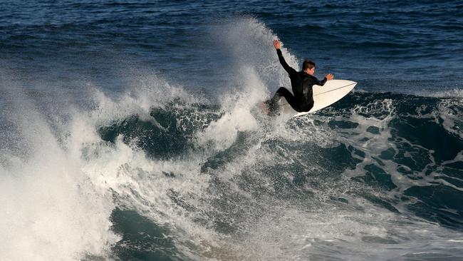 A surfer rides a wave at Maroubra Beach. Picture: Damian Shaw