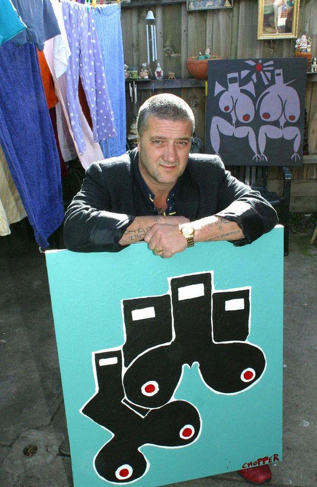 Mark “Chopper” Read with one of his paintings in his backyard where he painted. Photo: HWT library