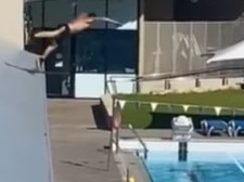 A video has been posted online showing a man scaling a fence then diving into a public swimming pool. Social media users have blasted him for his recklessness. Picture: The Bell Tower Times