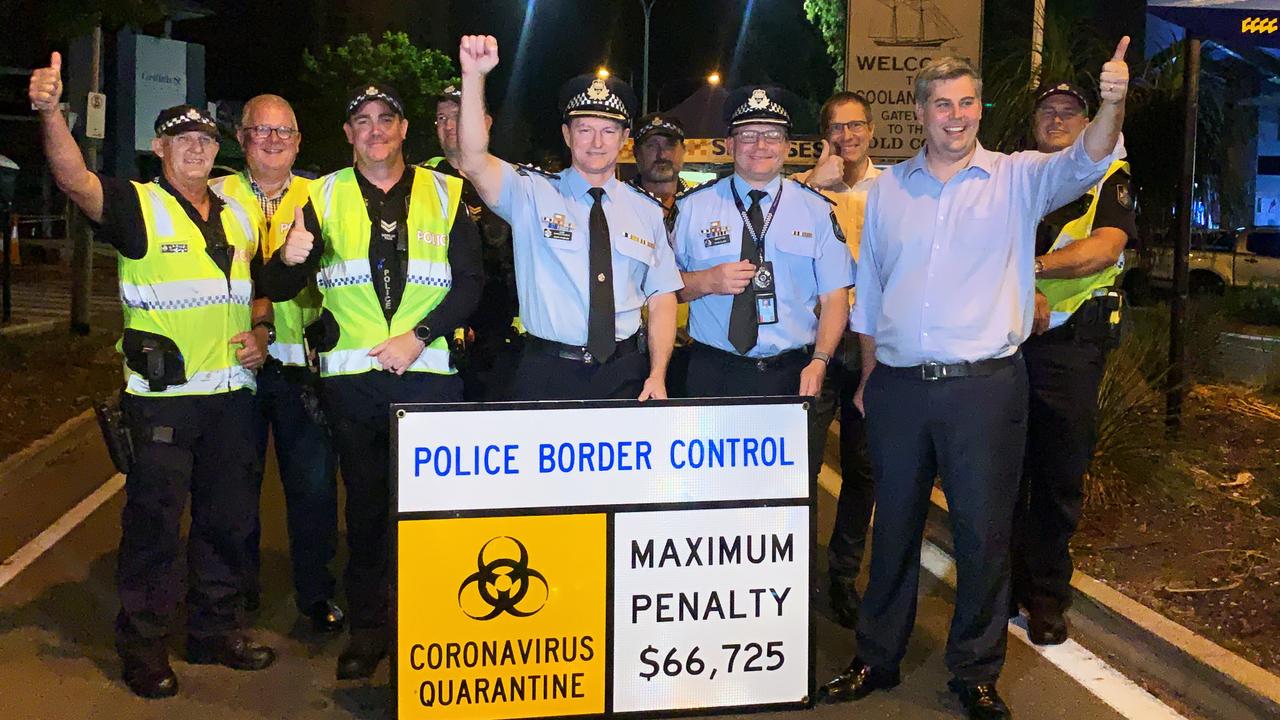 Queensland Police Superintendent Mark Wheeler and Police Minister Mark Ryan celebrate the border reopening with police and Griffith Street checkpoint staff. Picture: Scott Powick