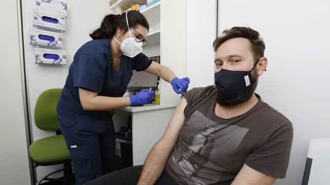 Jonathan Longden, 38, receives his 4th Covid shot in Morayfield, north of Brisbane. Picture: Lachie Millard