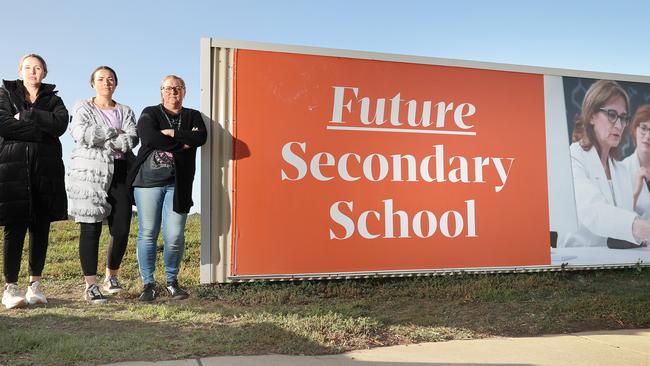 Armstrong Creek parents and residents Jacky Basset, left, Lauren Piechota and Sherryn Vessey at the site earmarked for a secondary school in 2024. Picture: Alison Wynd