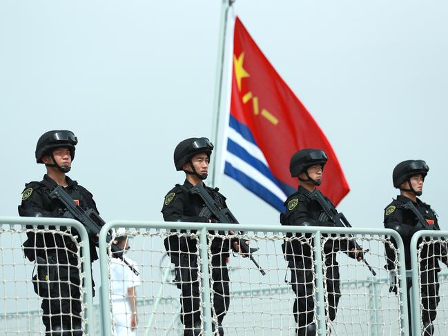 ZHOUSHAN, CHINA - MAY 18: Members of the Chines Navy stand on the deck of a navy ship at a military port on May 18, 2022 in Zhoushan, Zhejiang Province of China. The 41st fleet from the Chinese People's Liberation Army Navy left Zhoushan on Wednesday for the Gulf of Aden and waters off Somalia for escort missions. (Photo by VCG/VCG via Getty Images)