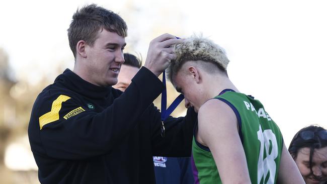 Richmond’s Tom Lynch awarding Nate Caddy with his “other medal”. (Photo by Daniel Pockett/AFL Photos/via Getty Images)