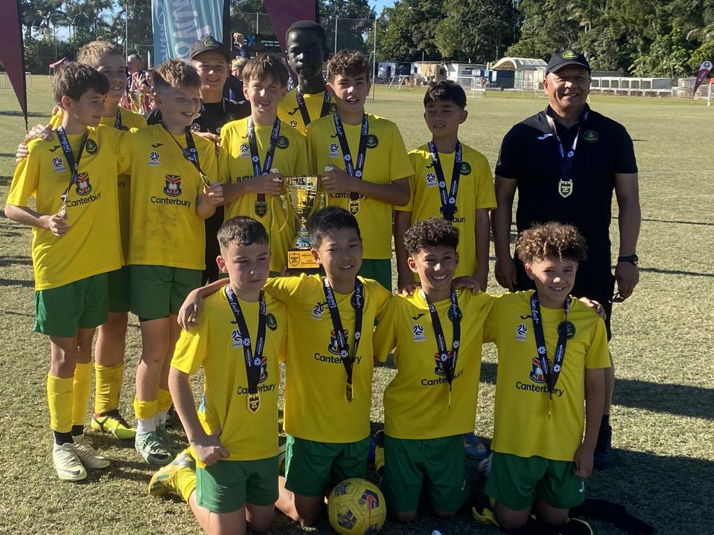 Rochedale Rovers under 12 boys claim the 2024 Junior Cup trophy during the Football Queensland Junior Cup finals. Picture: Eddie Franklin