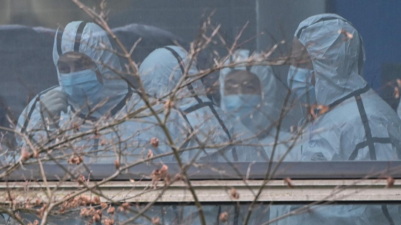 Members of the World Health Organisation during their visit to a centre for animal disease control and prevention in Wuhan. Picture: Hector Retamal/AFP