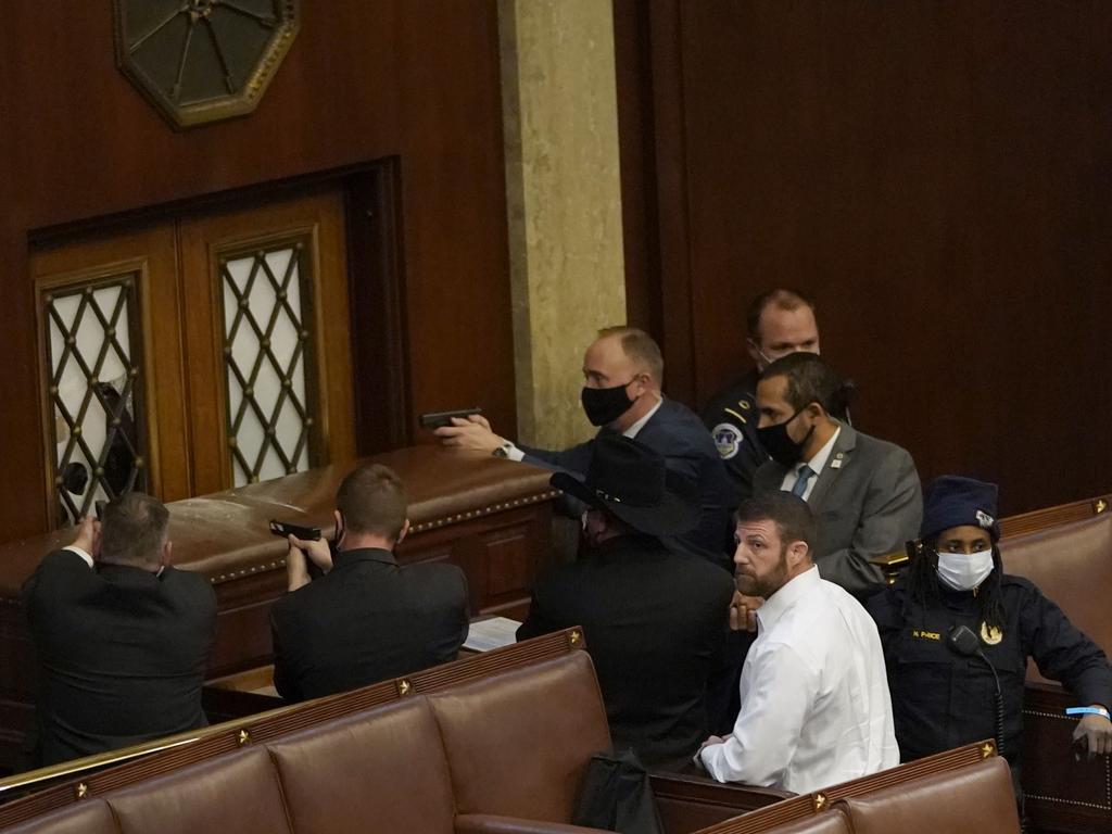 Capitol police officers draw their guns as rioters breached the House Chamber during the joint session of Congress. Picture: Drew Angerer/Getty Images/AFP