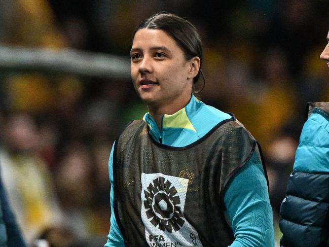 Australia's captain Sam Kerr (C) is seen on the touchline during the Australia and New Zealand 2023 Women's World Cup Group B football match between Canada and Australia at Melbourne Rectangular Stadium, also known as AAMI Park, in Melbourne on July 31, 2023. (Photo by WILLIAM WEST / AFP)