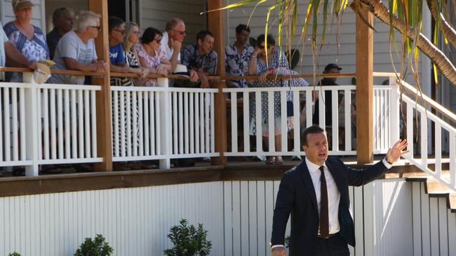 Dan Sowden calls the bidding at a property in Mudjimba Beach, on Queensland’s Sunshine Coast. The real estate industry fears buyers will shun auctions to avoid contact with other people. Picture: Erle Levey