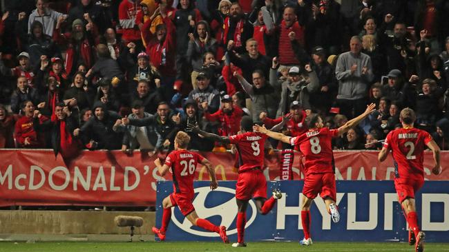 Ben Halloran celebrates his elimination final winner in front of Adelaide United supporters at Hindmarsh Stadium last season. Picture: Scott Barbour/Getty Images