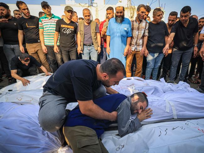 A relative mourns by the bodies of members of the Abu Morad family who died following Israeli strikes in Khan Yunis in the southern Gaza Strip. Picture: AFP