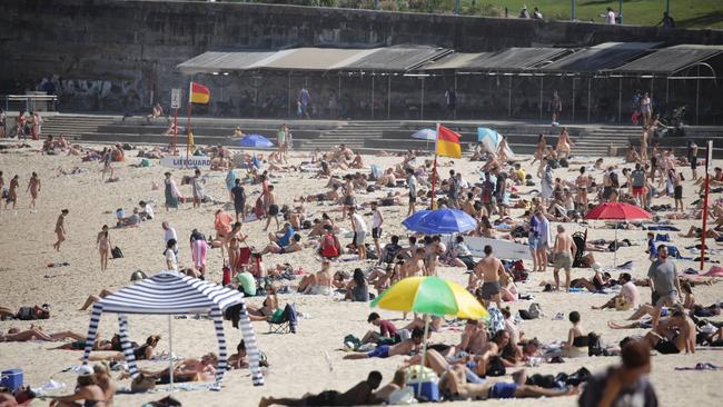 Hundreds of people enjoying Coogee Beach this week as temperatures increase. Picture: Christian Gilles