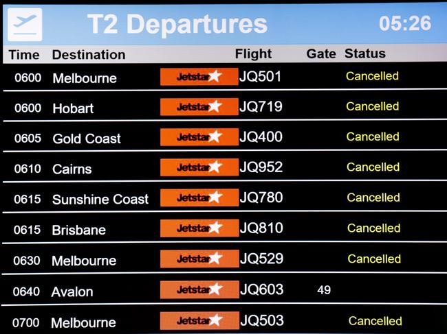 Jetstar flights are displayed as cancelled on a departures board at Sydney Airport on December 14. Picture: Getty Images