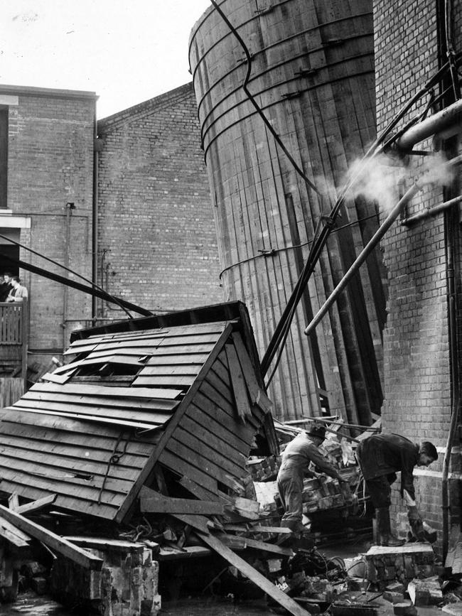 The scene after a 44,000 gallon vat of gin burst at the former Federal Distillery in Rouse St in 1951.