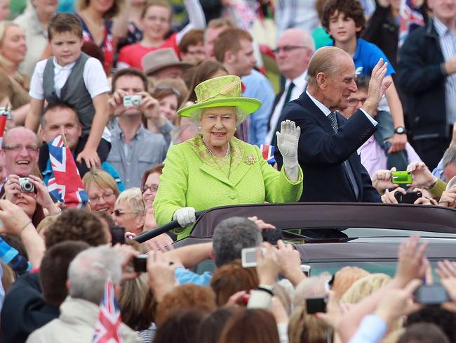 The Queen and Prince Phillip drive in a open top car at a special Diamond Jubilee event in the grounds of the Stormont Estate in Belfast. Picture; AFP.