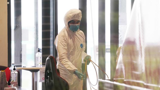 Cleaners at Essendon’s headquarters yesterday. Picture: AAP