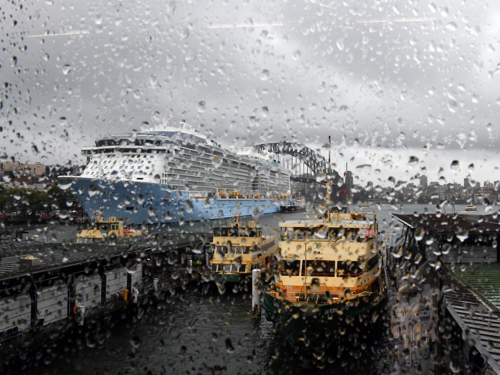 Rain droplets are seen on the window of the Circular Quay train station as clouds cover the Sydney Harbour on November 28, 2018. - Flights were cancelled, railway lines closed and motorists stranded on flooded roads as a month's worth of rain fell on Sydney early on November 28, leaving emergency services battling to respond. (Photo by Saeed KHAN / AFP)