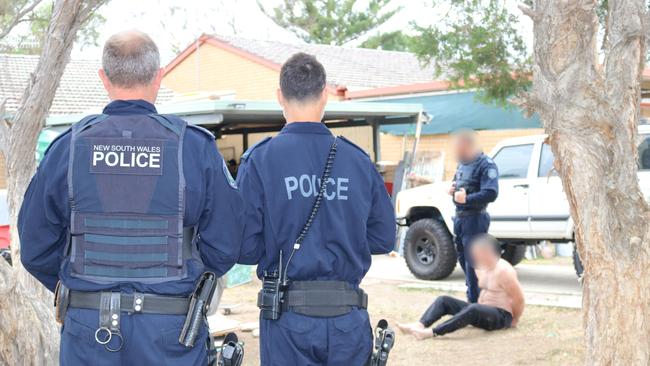 Brett Roe is arrested on his front lawn. Picture: NSW Police Force. 