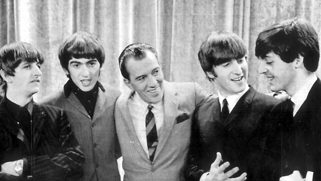 TV personality Ed Sullivan (centre) pictured with The Beatles in 1964.