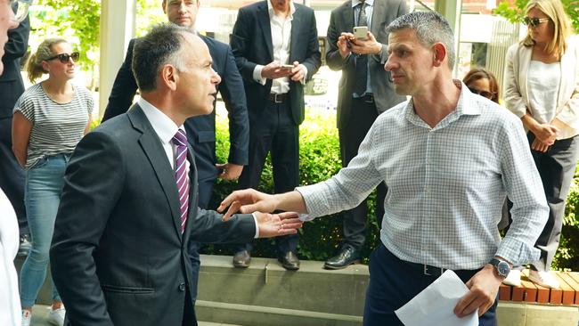 Wayne Gatt, chief of The Police Association Victoria is greeted by the Opposition Leader John Pesutto outside Spencer St headquarters on Friday. Picture: Luis Enrique Ascui