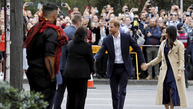 Crowds watch on as the royal couple stroll through Fitzroy. Picture: AP