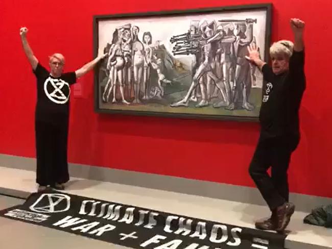 The protesters gluing themselves to the Picasso painting in the National Gallery of Victoria.