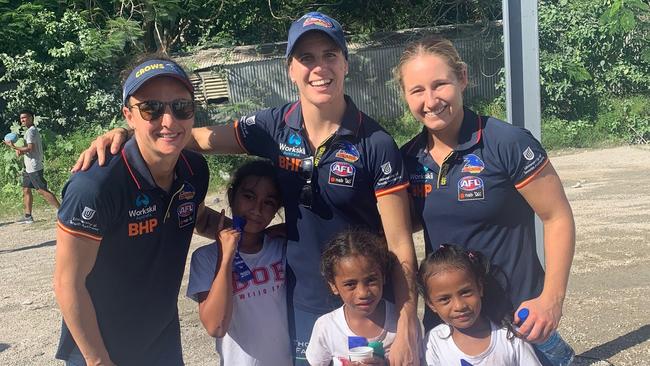 Crows AFLW players Angela Foley (L), co-captain Chelsea Randall and Nikki Gore with Nauruan children in Nauru. Picture: Supplied, Adelaide Crows