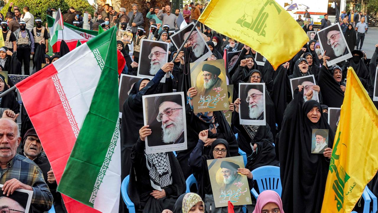 Demonstrators wave flags of Iran, Lebanese Hezbollah, and pictures of Iran's Supreme Leader Ayatollah Ali Khamenei and the slain Hezbollah Leader Hassan Nasrallah during an anti-Israel rally in Tehran on October 24, 2024. Picture: AFP