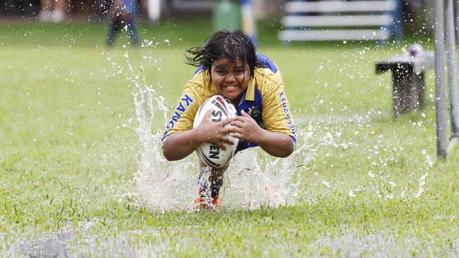 With Tropical Cyclone Megan threatening the Northern Territory and Queensland border, heavy rain is forecast for Cairns this week. FNQRL ball boy Thomas Brim, 12, has fun diving into puddles at Vico Oval at the completion of the A Grade match between the Cairns Kangaroos and the Innisfail Brothers. Picture: Brendan Radke