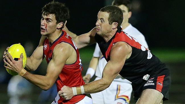 Norwood’s Steven Baldasso is tackled by West Adelaide’s Lachlan Jennings. Picture: Sarah 