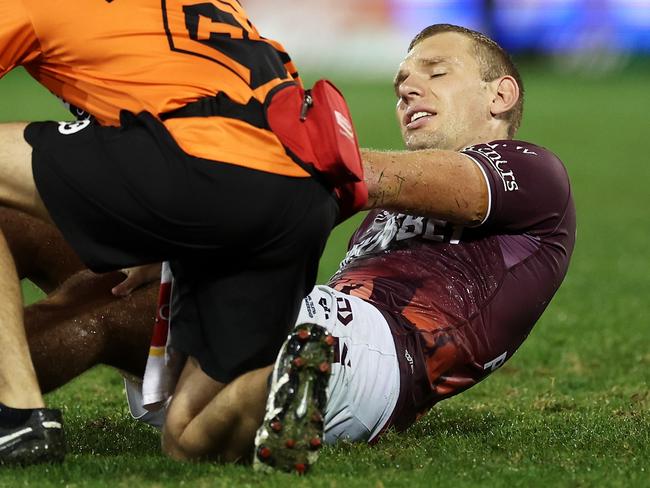 SYDNEY, AUSTRALIA - APRIL 23: Tom Trbojevic of the Sea Eagles receives attention from the trainer during the round eight NRL match between Wests Tigers and Manly Sea Eagles at Campbelltown Stadium on April 23, 2023 in Sydney, Australia. (Photo by Mark Kolbe/Getty Images)