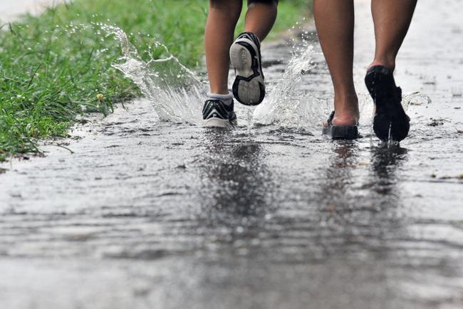 Wet weather makes it a struggle to pick up the children from school. Picture: Brenda Strong