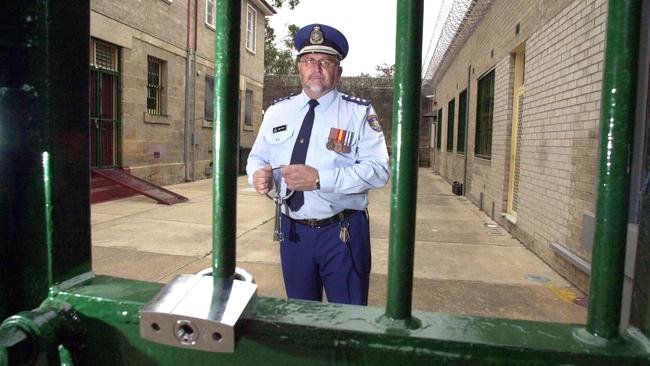 Former prison governor Barry Folpp at the gate of Cooma Correctional Centre, the 143-year-old prison where Oliver Curtis now lives. Picture: Ray Strange