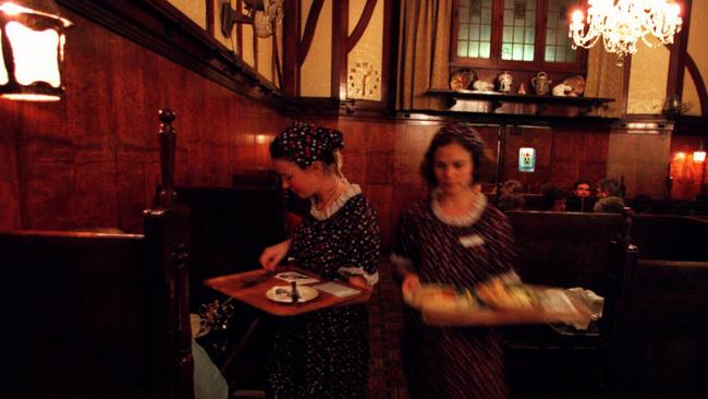 Waitresses carrying trays at Brisbane's original Shingle Inn tearoom in Edward Street
