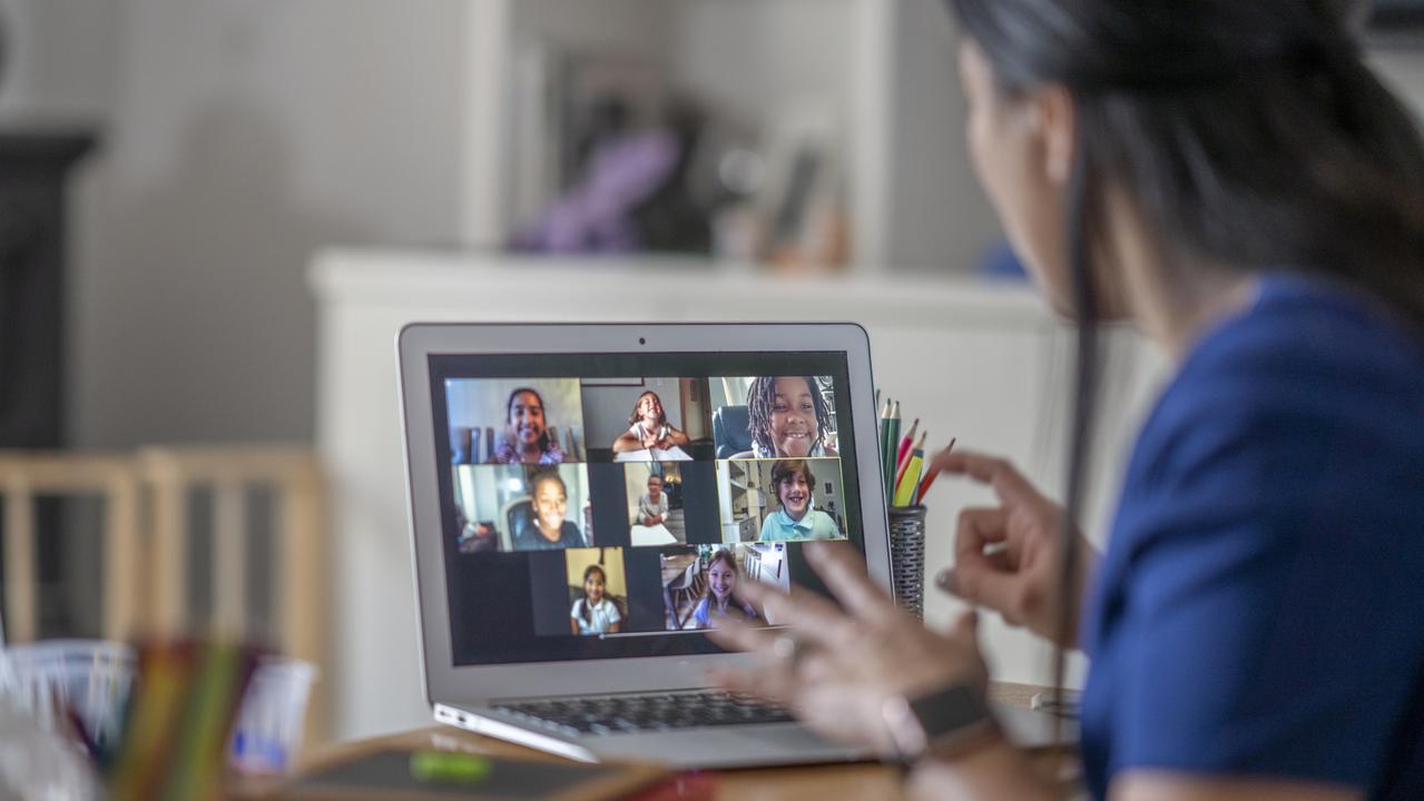 Female teacher working from home, using video chat to connect with her students during the COVID-19 pandemic.