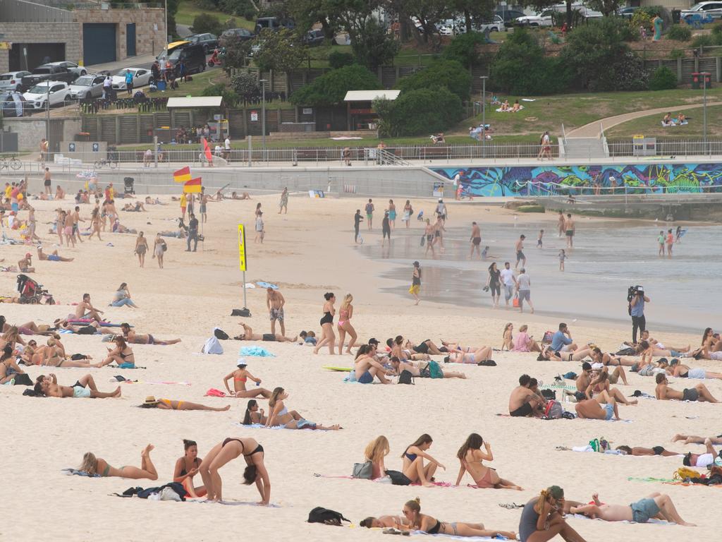 Beachgoers are seen on the sand prior to the closure of Bondi Beach in Sydney. Picture: James Gourley/AAP