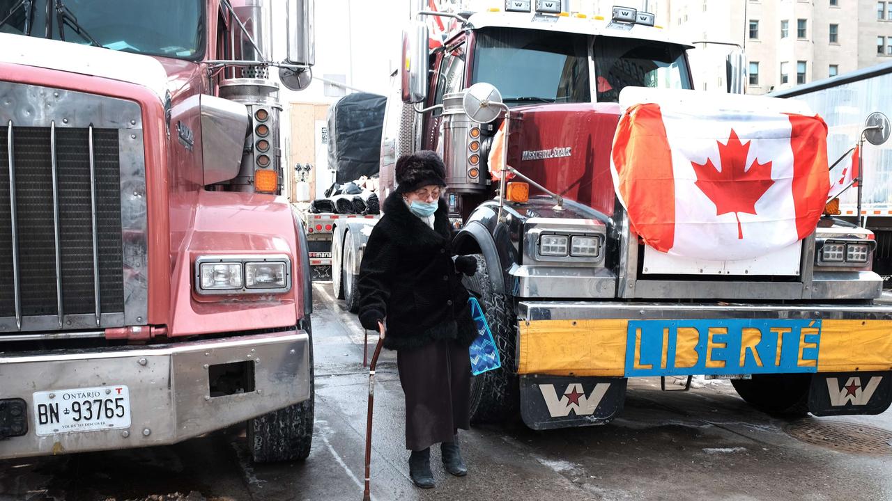 An elderly woman tries to navigate a downtown street as hundreds of truck drivers block the streets. Picture: AFP