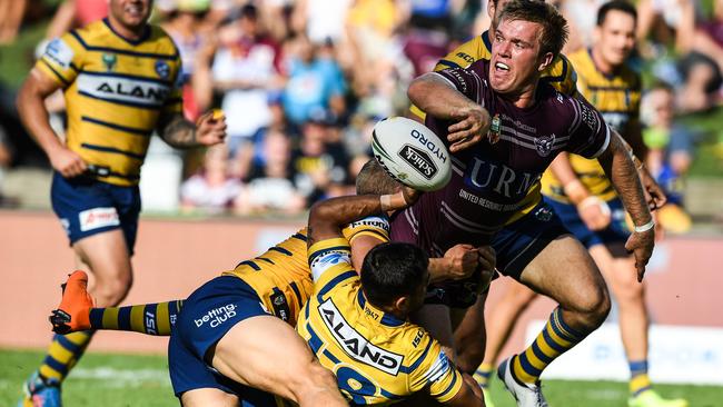 Manly’s Jake Trbojevic withstands heavy pressure to flick the pass that put Lachlan Croker over the line for his first try for the Sea Eagles. Picture: AAP