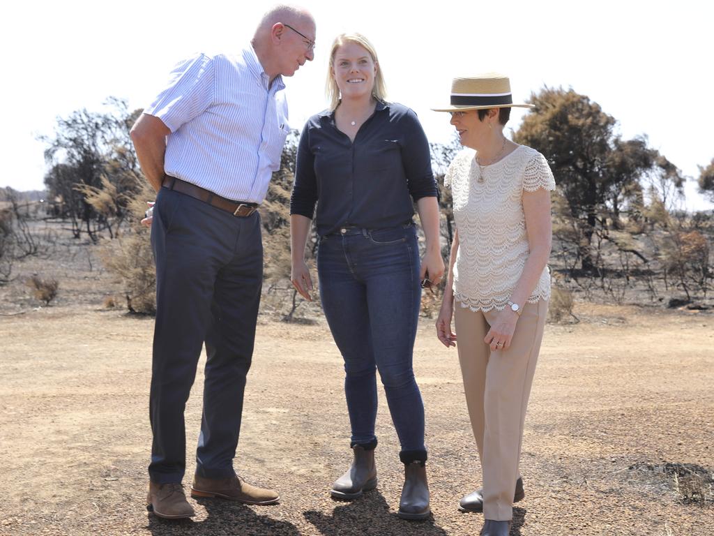 Stephanie Wurst who lost her home, has a rare moment to smile as she chats to Governor-General David Hurley and his wife Linda on Tuesday. Picture: Dean Martin