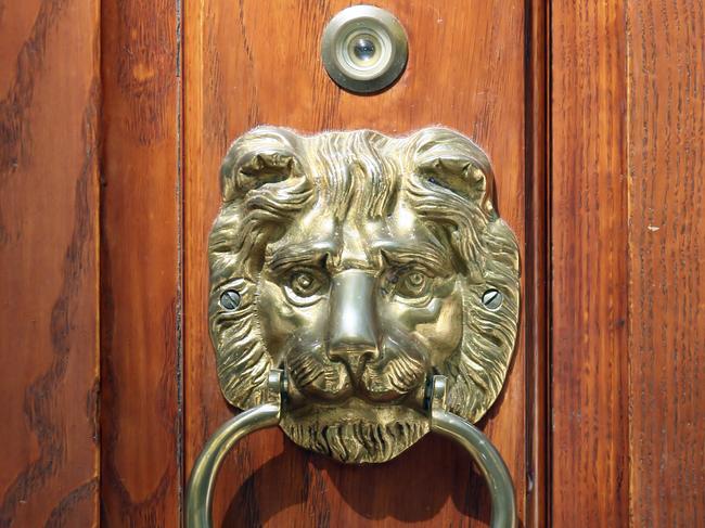 Oak door with brass lion head knocker.