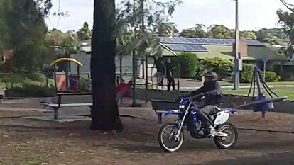 A dirt bike rider metres from a playground on Marston Drive in Morphett Vale.