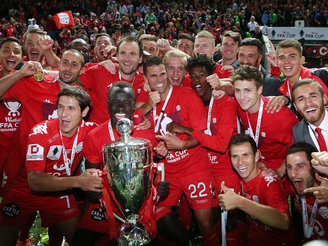 Adelaide United players celebrate their FFA Cup win. Photo: Sarah Reed.