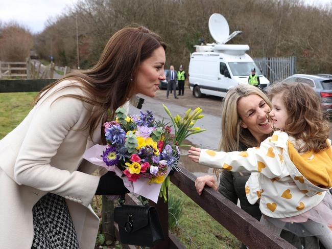 Toddler Cora Phillips gives the Princess a bunch of daffodils, the national flower of Wales in Llanharan, near Pontyclun. Picture: AFP