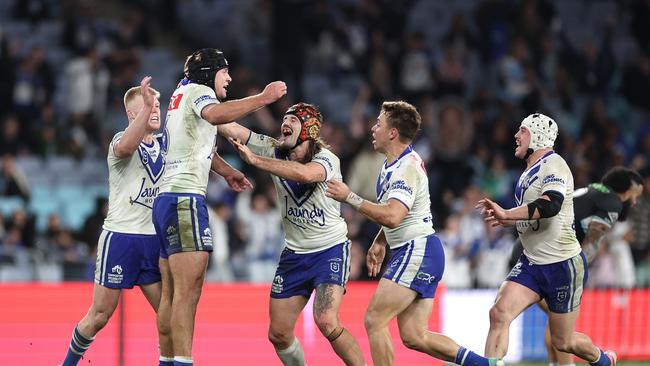 SYDNEY, AUSTRALIA - JUNE 28:  Matt Burton of the Bulldogs celebrates with team mates after kicking a golden point field goal in extra time to win the round 17 NRL match between Canterbury Bulldogs and Cronulla Sharks at Accor Stadium on June 28, 2024, in Sydney, Australia. (Photo by Cameron Spencer/Getty Images)